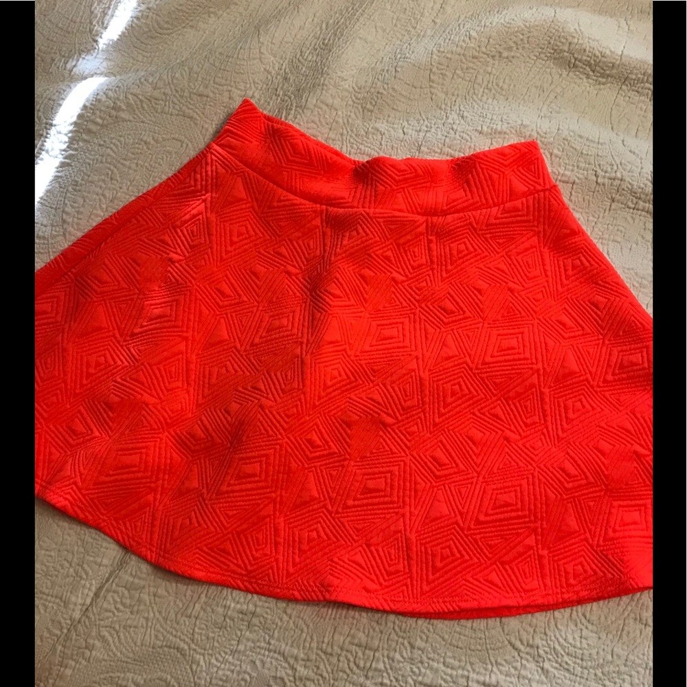Bright neon orange skater skirt.
